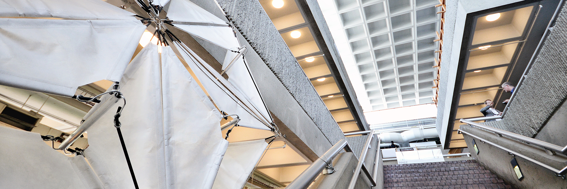 A photo of architectural sails installed to the left of the central stairway of the Architecture West Building.