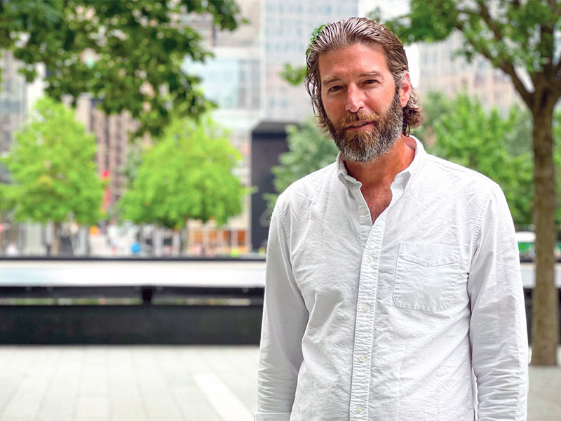 Michael Arad stands in front of the 9/11 Memorial at the World Trade Center Site.