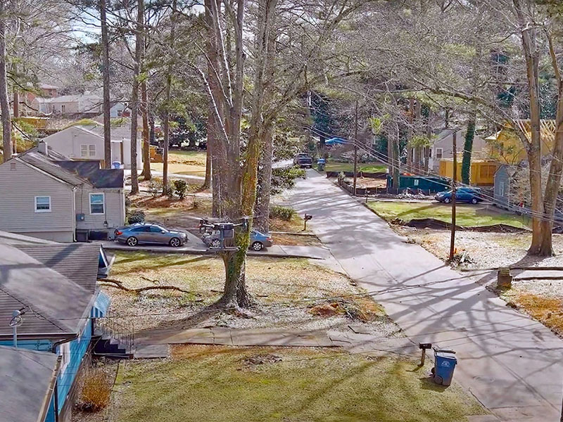A drone photograph of a house-lined street in Grove Park