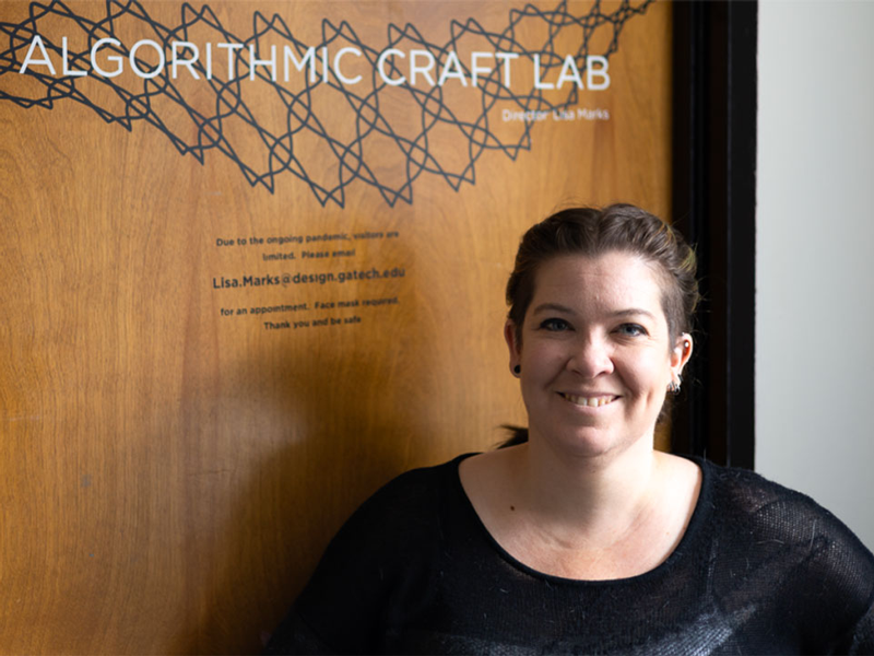 Lisa Marks in front of the door to her "Algorithmic Craft Lab"