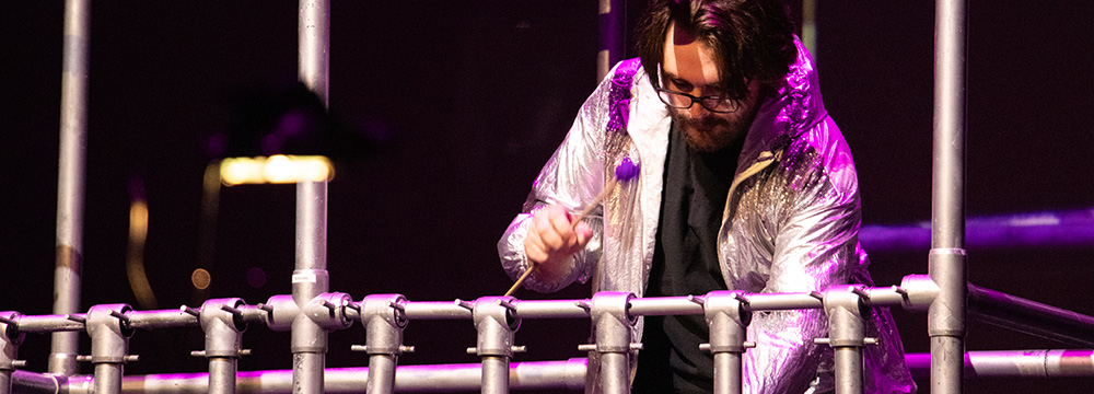 A Guthman performer plays a new musical instrument made of electromagnetic pipes.