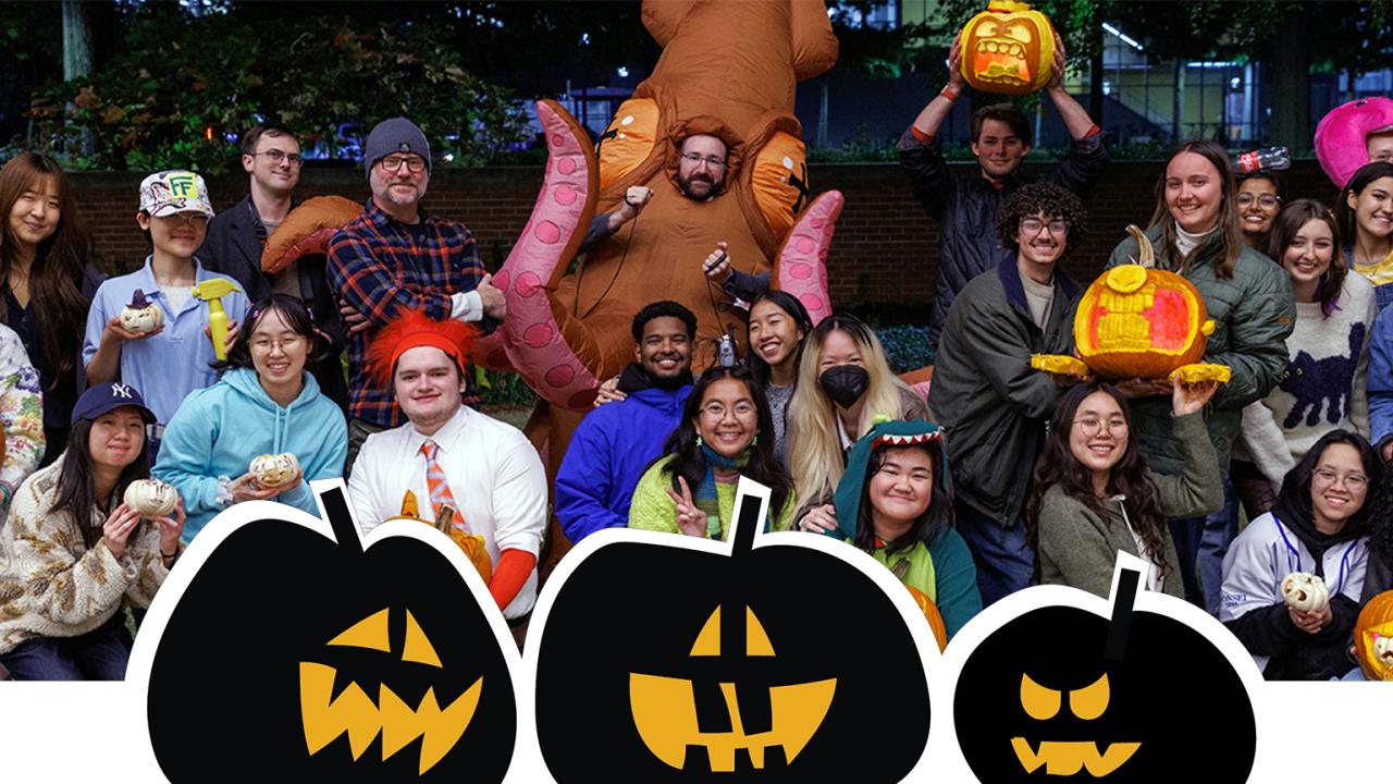 A photo of Industrial Design students dressed for Halloween, holding up Jack-o-lanterns.
